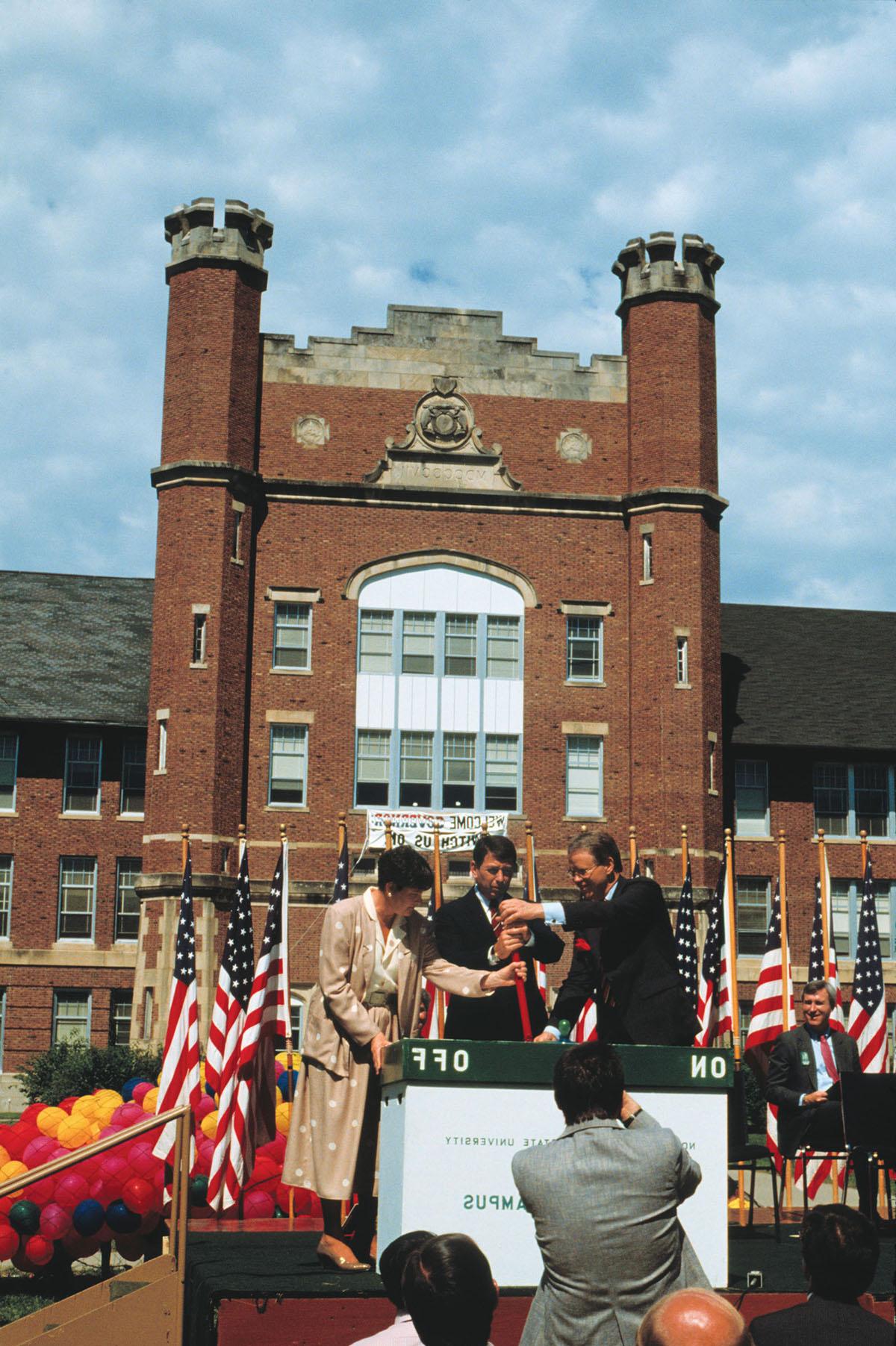 Northwest President Dean Hubbard (left) pulls a ceremonial switch, marking the launch of the University’s “Electronic Campus” on Aug. 18, 1987, with Gov. John Ashcroft and Shaila Aery, Missouri’s commissioner for higher education. Northwest was the first public university in the nation to have a campus-wide computing system.